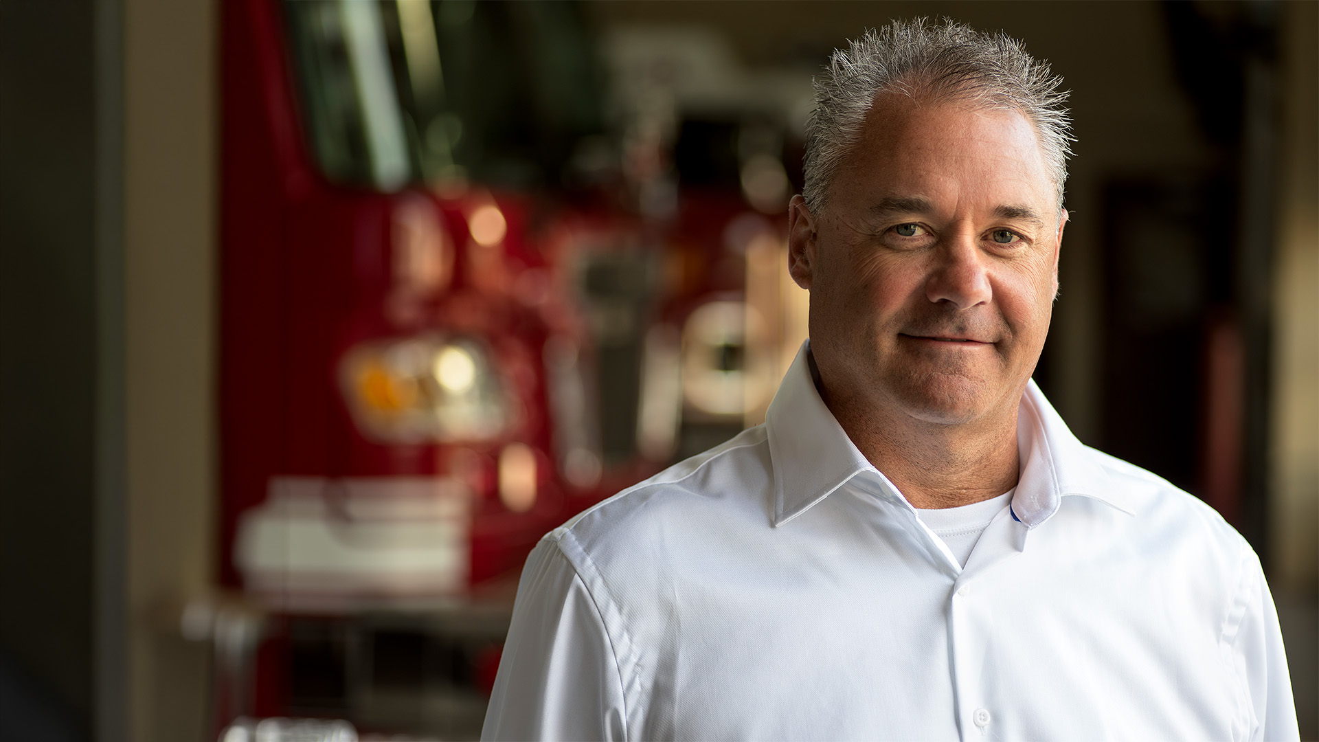 Jared Gapinski, conservative Minnesota Senate candidate and former Fire Captain, pictured in front of a Sauk Rapids firetruck